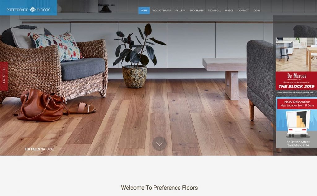 A cozy room with natural wood flooring, a wicker chair with a cushion, a low wooden table, and a potted plant. The website header and menu for "Preference Floors," designed by the web design and branding service Spark Interact, are at the top of the page.