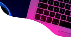 Neon-lit laptop keyboard with a glimpse of a screen displaying blue graphical data, set against a dark background.