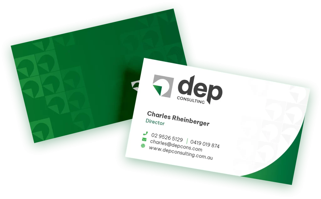 Two business cards in a green holder with contact details for charles rheinberger, director at dep consulting. the cards display phone numbers and an email address.