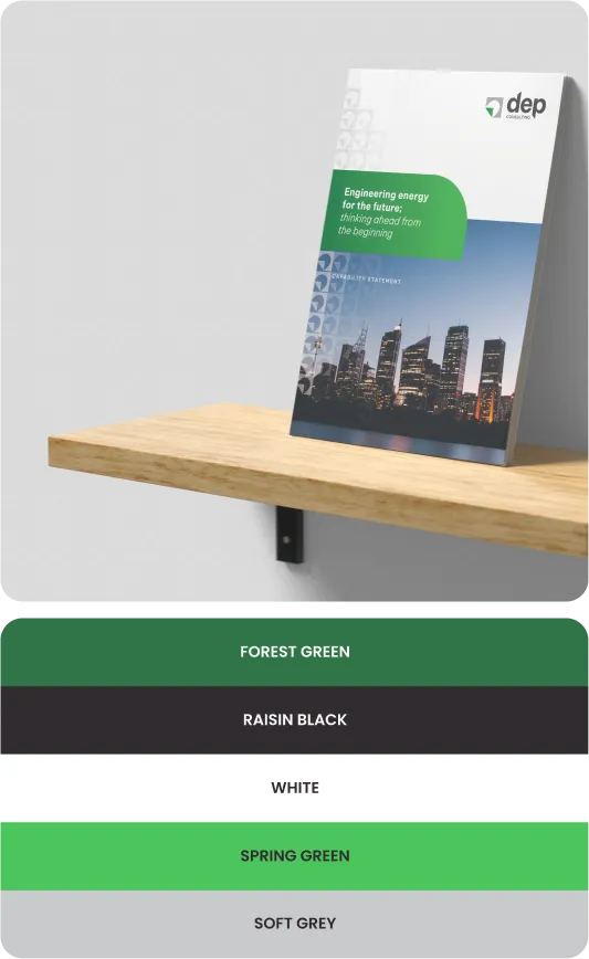 A brochure with a cityscape cover design placed on a wooden shelf against a grey wall, labeled with color options below.